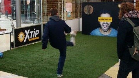 Speedkick-Anlage mit zwei Aluminiumtoren und umlaufendem rotem Bandensystem mit RB-Leipzig-Branding, aufgestellt auf Kunstrasen in einer Halle, Frontalansicht